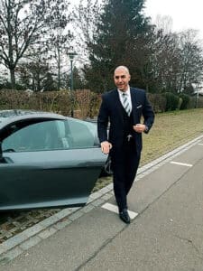 Oliver Martin Biography 22 OLIVER MARTIN Oliver Martin, Swiss entrepreneur with luxury car showcasing business success and lifestyle